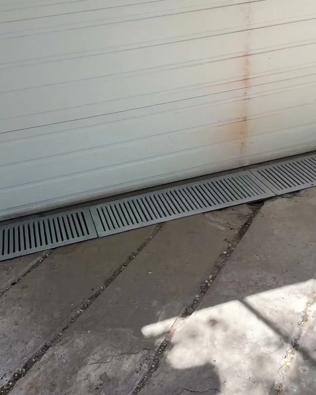 Custom driveway & surface drainage grates flush-fit at the garage door line in The Beaches, Toronto — The Grate Guys